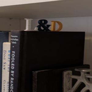 Decorative items on a shelf with books and a small sculpture.