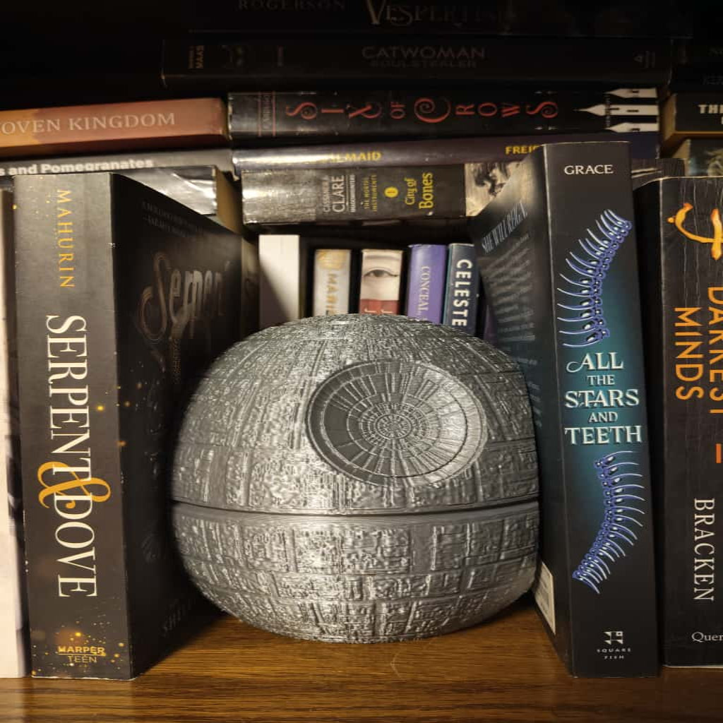 Death Star model among books on a shelf