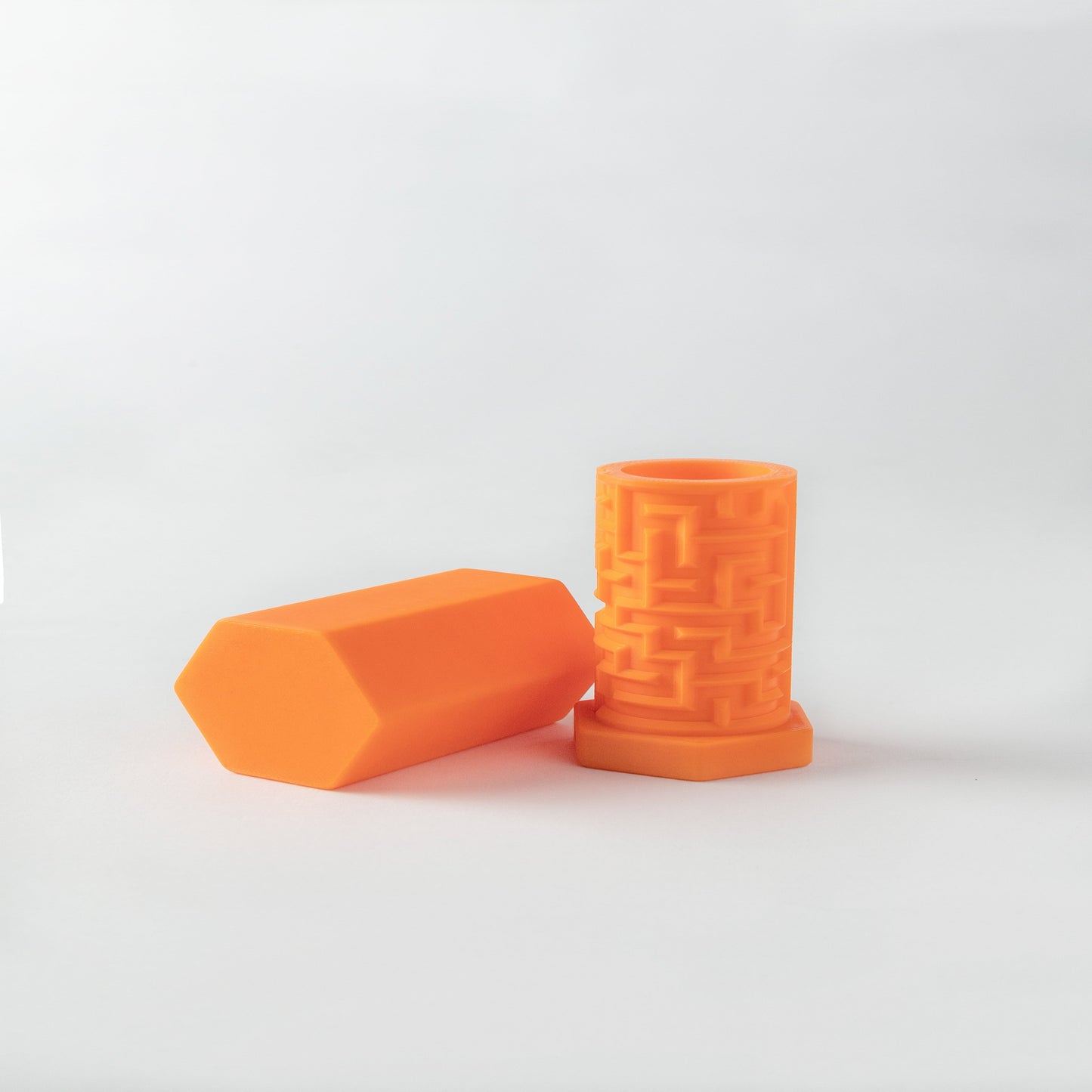 A 3D-printed orange puzzle box with a geometric pattern designed to be twisted and turned to unlock a compartment.