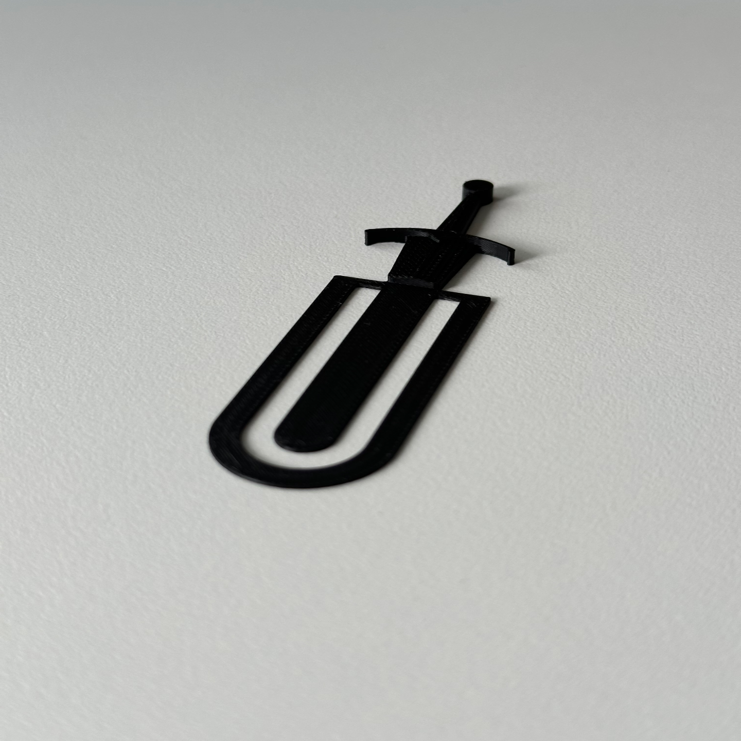 Black paper clip on a white background