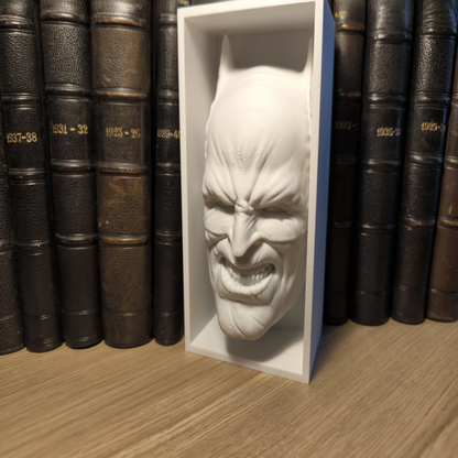 White mask in a box on a wooden surface with books in the background