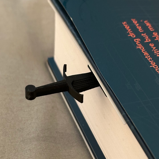 Black clip on a book with text in the background