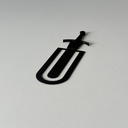 Black paper clip on a white background